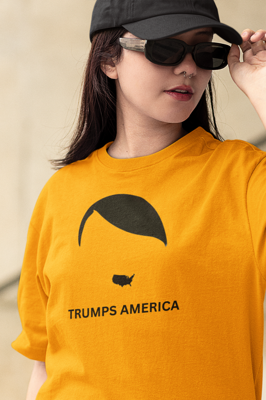 Person wearing a mustard yellow t-shirt with 'TRUMPS AMERICA' text and graphic.
