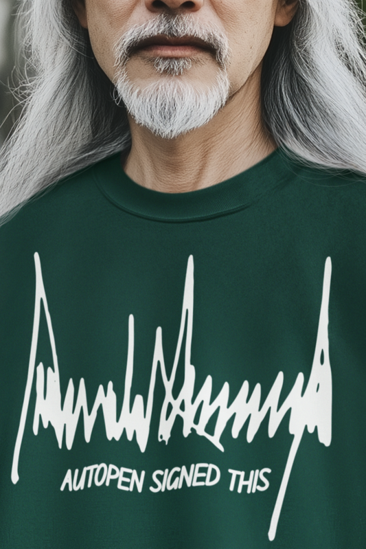 Man wearing a green sweatshirt with text and an orange beanie outdoors.